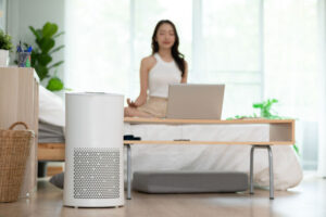 woman meditating in room with air purifier