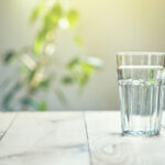 glass of water on table in sunlight