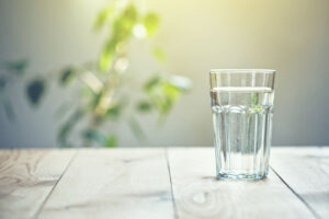 glass of water on table in sunlight