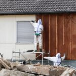 workers investigating home for asbestos insulation