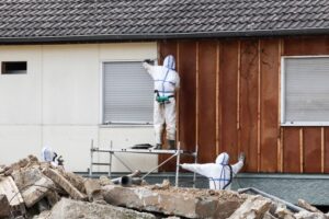 workers investigating home for asbestos insulation