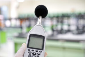 Measuring the noise in laboratory room with a sound level meter.