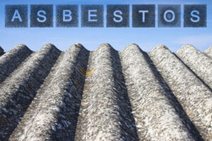 "Asbestos" written in block letters above a degrading metal roof